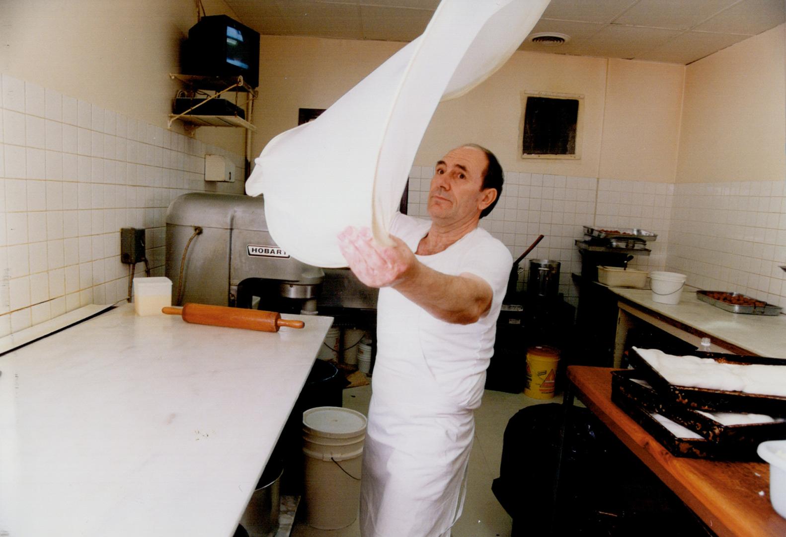 Taste of athens: Evangelos Tsioutsioulas stretches phyllo.