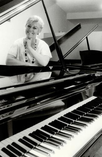 Vand now: At 42, famed singer Vanda King sits contentedly at a grand piano at her Etobicoke piano restoration business