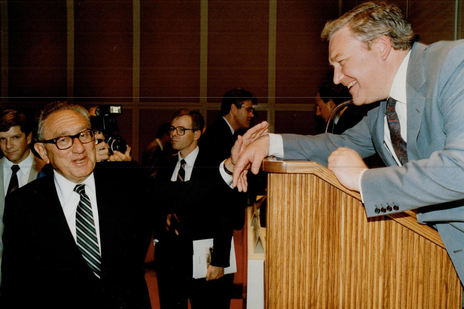 Old pals: Hollinger chairman Conrad Black, right, extends a hello to Henry Kissinger, one of the media concern's 22 directors, after the annual meeting yesterday