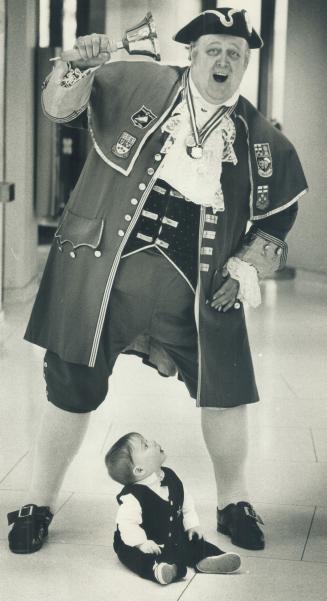 A far crier: Frank Knight, a City of Scarborough town crier, grabs the attention of young Jonathan Ostrom