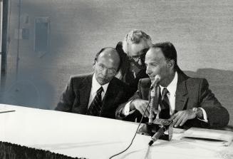 Pass it on: Cadillac Fairview chairman Leo Kolber, left, and president Bernard Ghert, right, confer with public relations man Bert Petlock at yesterday's new conference