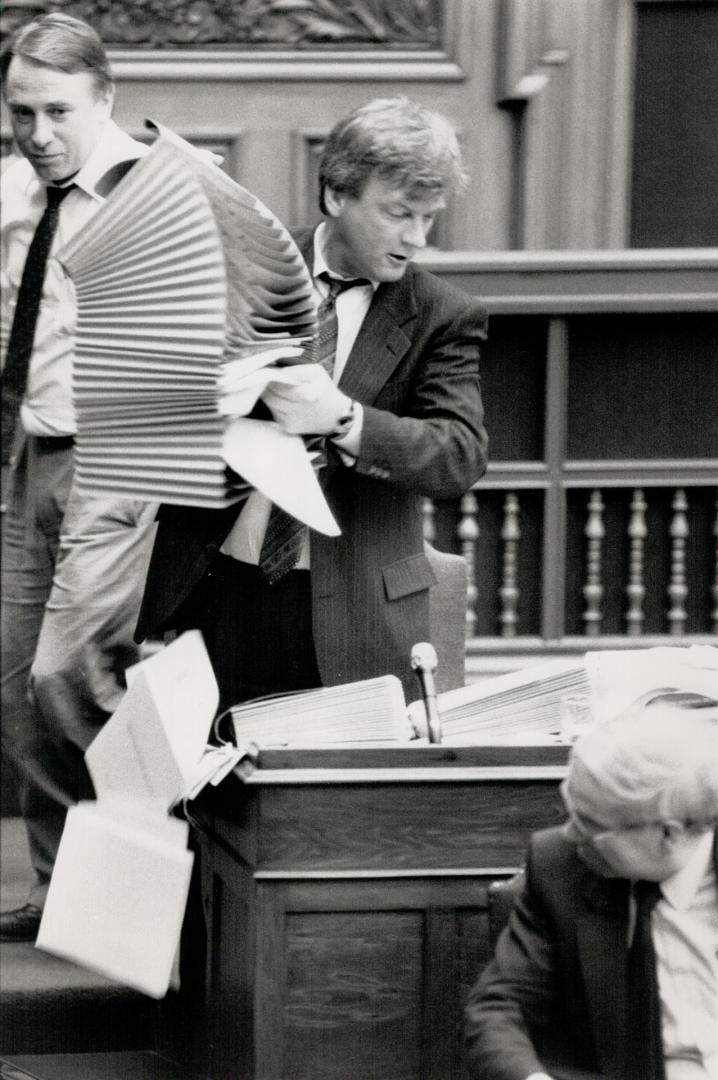 Filing system: New Democrat MPP Peter Kormos empties fire on his desk at Legislature yesterday during 17-hour fillbuster over auto insurance bill.