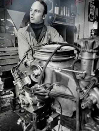 Horst Kroll Canadian driving champion, points out the benefits of the Porsche engine that carried his Kelly-Porsche to title