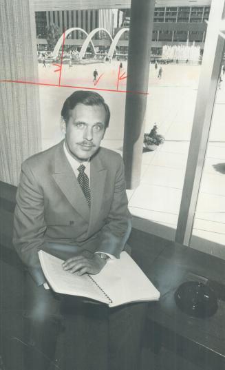 John Kruger, executive assistant to Metro chairman Ab Campbell, sits in his office overlooking Nathan Philips Square