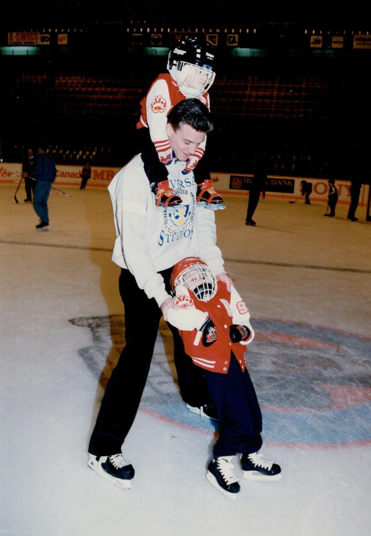 Mike Krushelnyski carries son Alexander, 2, and pushes Andrew, 4, at team Christmas party yesterday which followed a workout. More on Leafs