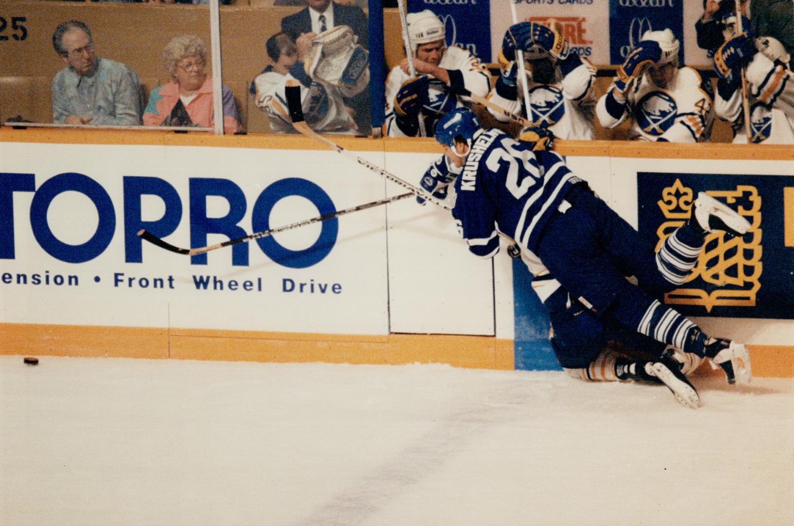 The big hurt: Leaf's Mike Krushelnyski shows aggressiveness Wednesday when he takes an unidentified Buffalo Sabre player heavily into the boards