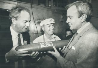 Hot-dogging: There's lots of Frank Miller baloney around these days, Liberal candidate Monte Kwinter, left, seems to be saying as he hands his leader David Peterson a chunk of same