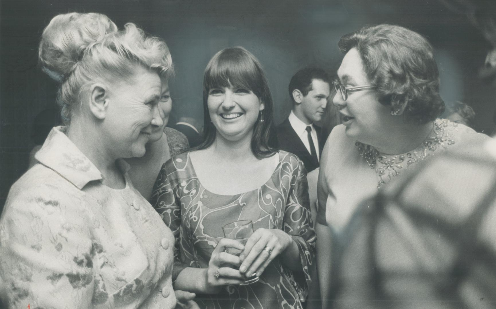 After the bolshoi opening of the ballet Quixote last night, Ekaterina Furtseva (left), Soviet minister of culture and wife of Russia's deputy minister of external affairs, talks with Canadian folk singer Sylvia Tyson (centre) and State Secretary Judy LaMarsh at a post-ballet reception