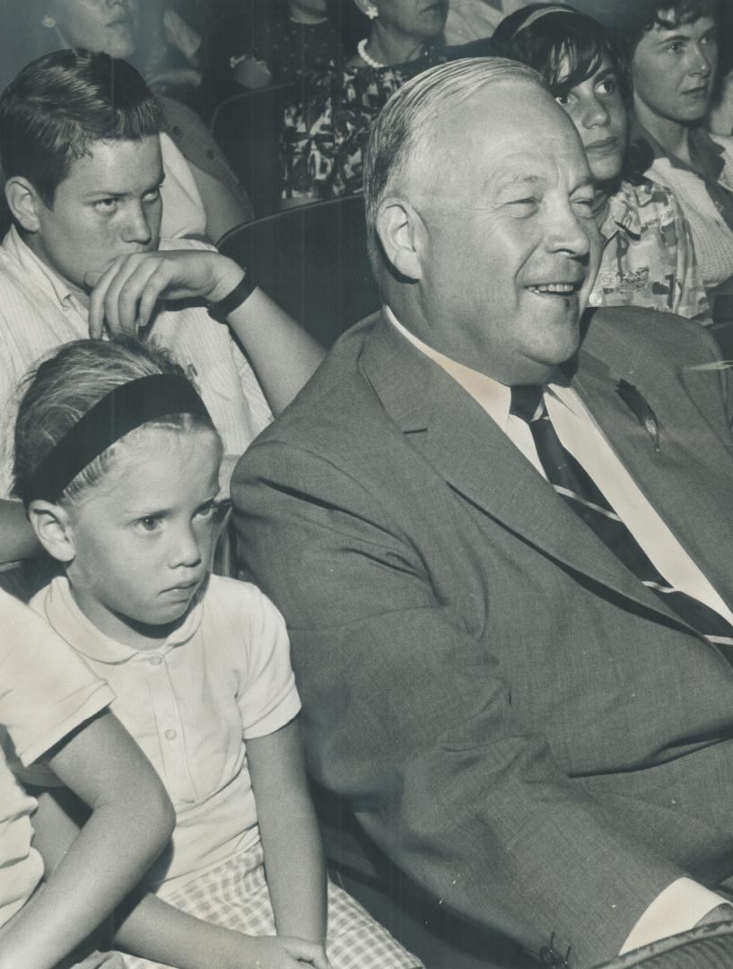 Controller Allan Lamport sits smilingly among a group of serious-faced teenagers while attending a screening of The Beatles' movie A Hard Day's Night at The Star's request this week