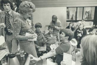 Francoise Laporte, widow of the Quebec labor minister who was kidnapped and murdered two years ago, signs autographs after officially opening Pierre Laporte Junior High School in Downsview last night