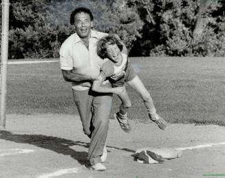 On to score. Mayor Mel Lastman can't get rundown in this steal of home plate since he's bringing in third baseman Keiron Smith, 9, with him.