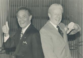 Hand jive: North York Mayor Mel Lastman, left, and Scarborough Mayor Gus Harris show their differing reactions to the province's announcement yesterday that municipalities will rule on Sunday store openings