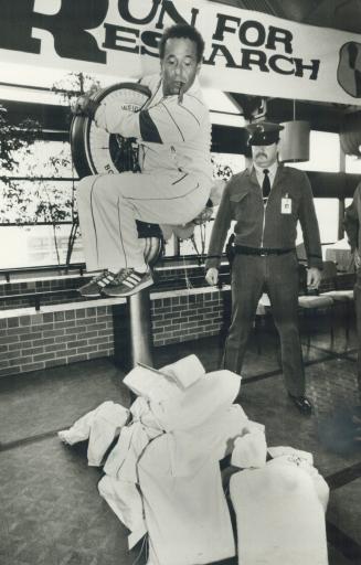 Lastman weighs in at $70,400, North York Mayor Mel Lastman looks down at his weight in $2 bills on the scale at city hall yesterday.