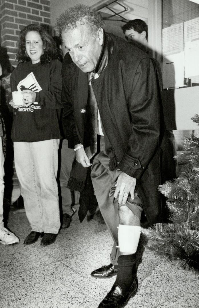 Battle Scar: Mayor Mel Lastman hikes up a trouser leg yesterday to show where he was kicked in the shin during a melee over a flag-raising ceremony at the North York civic centre's square on Sunday