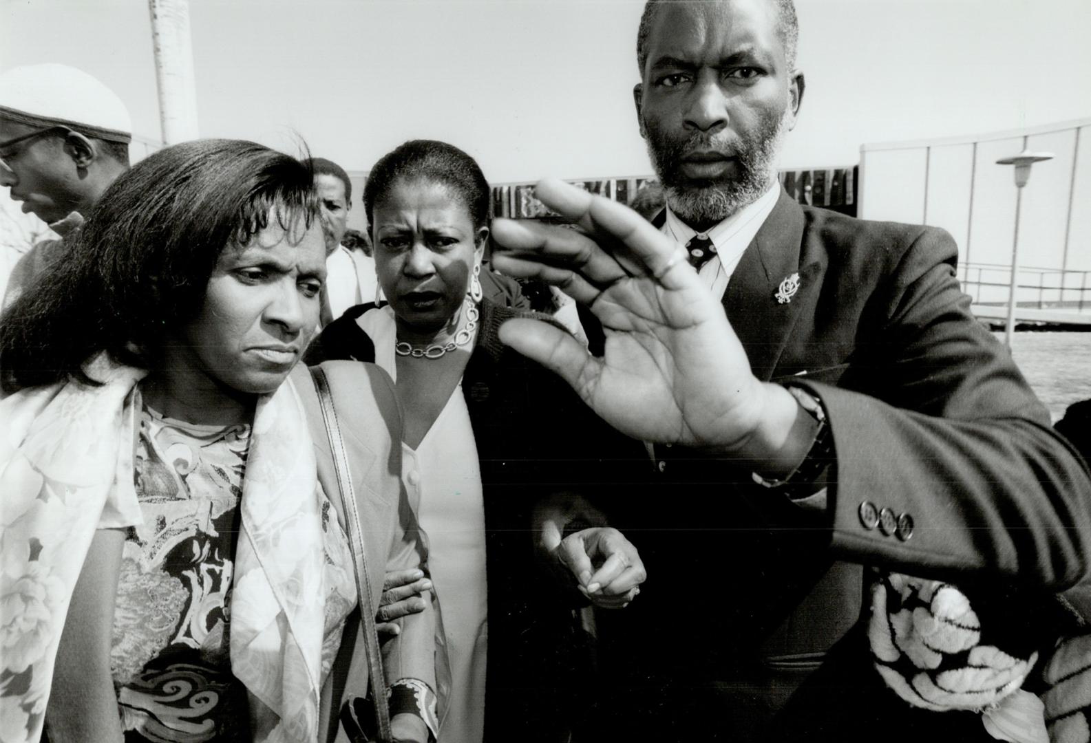 After the verdict: Supporters clear path for Evelyn Lennon-Lyon, centre, mother of Michael Wade Lawson, insert left, after verdict acquitting Anthony Melaragni, centre, and Darren Longpre