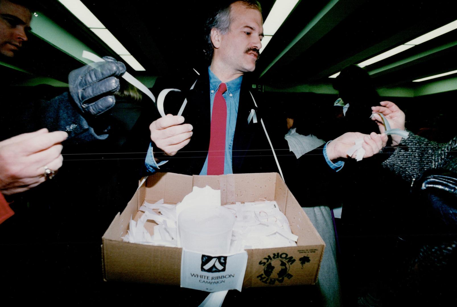 Former mayoral candidate Jack Layton hands out white ribbons - symbol of the campaign against violence towards women - at Union Station during rush-hour yesterday