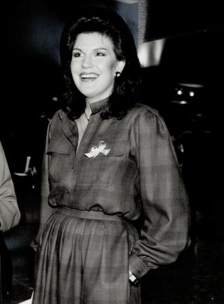 Above, Mary Carr-Harris, wearing a turquoise fol jacket and black skirt by Valentino, stand with new skinny Catherine Leggett, wearing a plaid Given luncheon dress