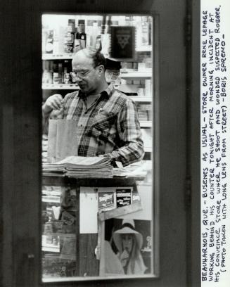 Store owner Rene Lepage working behind his counter tonight after morning incident at his conveince store where he shoot and wonded suspected robber.