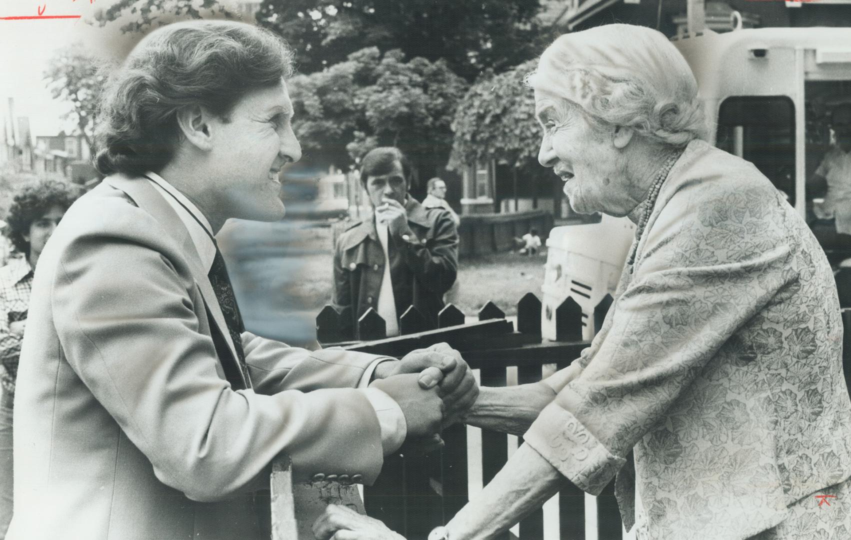 Before making his last swing through northern Ontario, NDP Leader Stephen Lewis chats with 84-year-old Stephanie Jarvis over the fence at Anglican Church Home for the Aged on Bellevue Ave