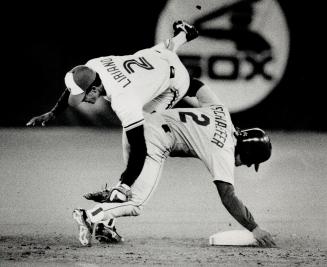 Clean block: Nelson Liriano gets upended at second base by Seattle pinch runner Jeff Schaefer, preventing Jays from completing a double play in the ninth