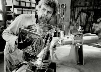 Space art: Sculptor Bill Lishman of Blackstock works on a full-scale model of the Canadarm, the remote-control arm used by the United States space shuttle Columbia