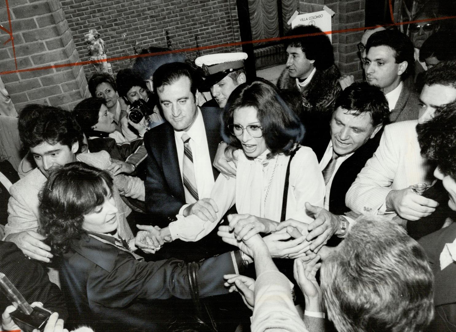 Sophia Loren: Mobbed by admires, the raven-haired actress shakes hands and returns greetings on her way to an award ceremony in North York