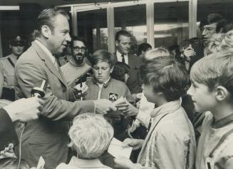 U.S. Astronaut James Lovell signs autographs and talks with scores of young people as he stands in the lobby of Toronto's McLaughlin Planetarium today. In Toronto to address the Empire Club last night, he visited the planetarium and the Ontario Science Centre