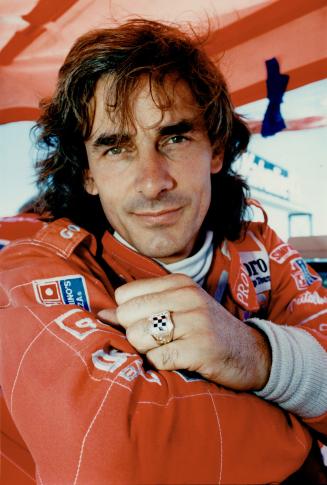 Arie Luyendyk blasts along the Detroit street circuit (top)