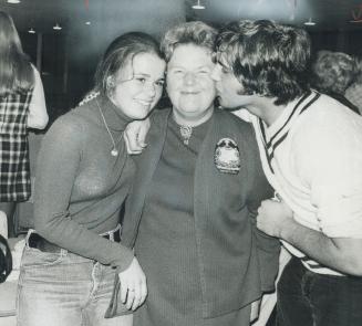 Anne MacArthur, the 63-year-old former teacher of history who was elected mayor of Milton last night, is congratulated by two students who worked on her campaign