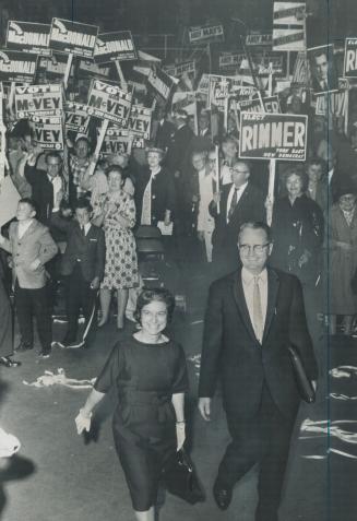 The biggest NDP rally of the provincial election campaign cheers party leader Donald MacDonald and wife as they enter Varsity arena last night