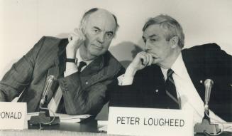 Donald Macdonald, left, and Peter Lougheed trade asides at a news conference yesterday to express business support for the free trade deal.