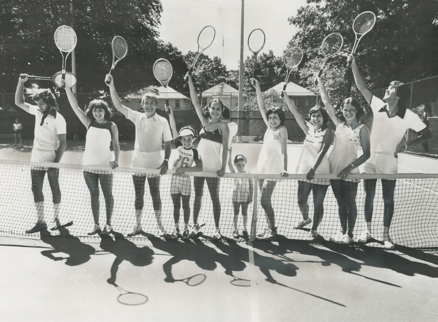 Tennis is a way of life for Dr. John MacDonald, his wife, Madeleine, and their eight children. In fine form at Moore Park Tennis Club - which they dominate - are, from left: Fraser, Kathy, Dr. MacDonald, John, Barbara, Hilary, Marie, Jennifer, Mrs. MacDonald