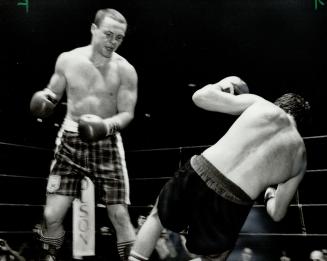 Going down: Challenger Roddy MacDonald watches as champion Gary Summerhays heads for the canvas duing their Canadian light heavyweight championship fight last night at the CNE Coliseum