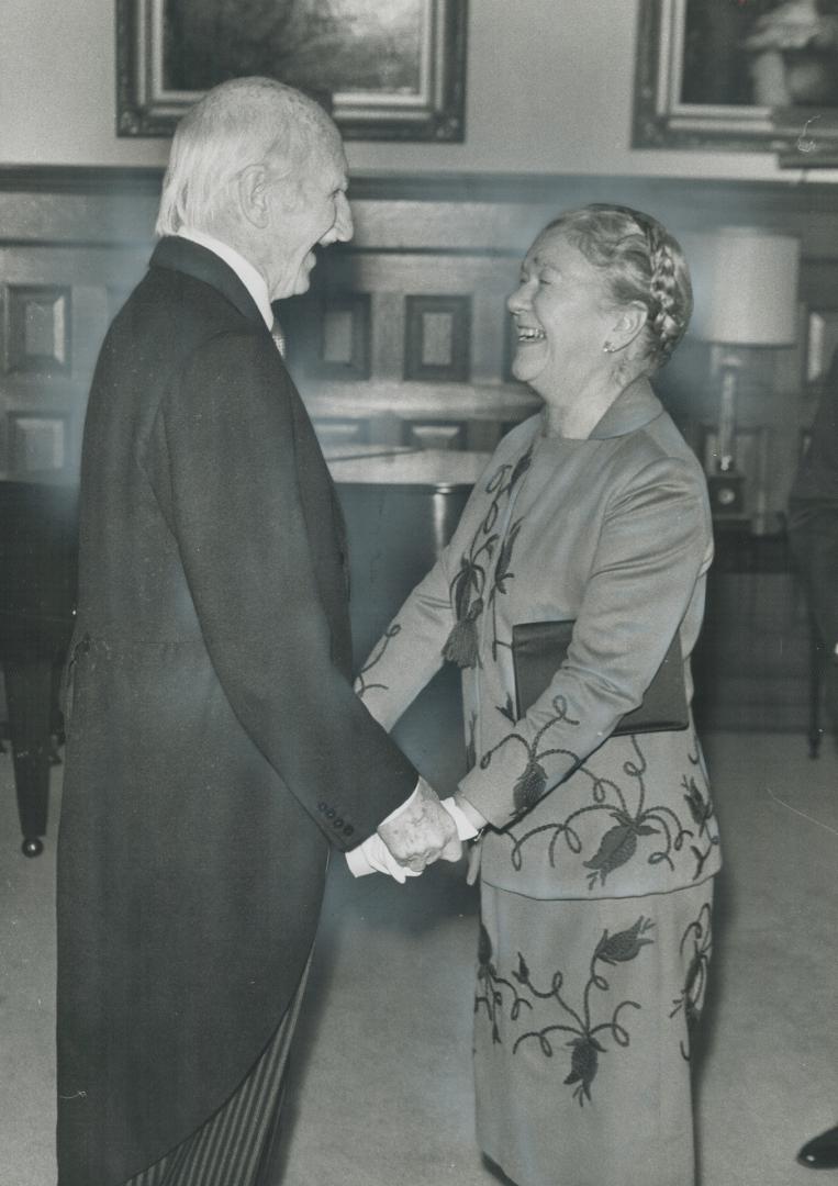 At Queen's Park - 'Happy New Year'. Ontario Lieutenant-Governor Ross Macdonald gives a warm welcome to Dr. Pauline McGibbon, the recently appointed chancellor of University of Toronto, at his New Year's Day levee, attended by more than 550 guests at Queen