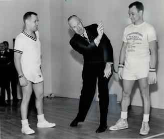 Metro police chief James Mackey serves. Opens handball tourney. Harold Kochberg watches