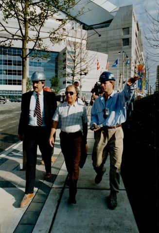 SkyDome inspection: SkyDome chairman Charles Magwood, right, and CN Real Estate president Doug Tipple, left, take works department official Nick Vardin on a tour of the site today