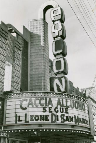 Marquee signage; Vertical section spells PYLON. Billboard section below reads, Caccia Alluoma S…