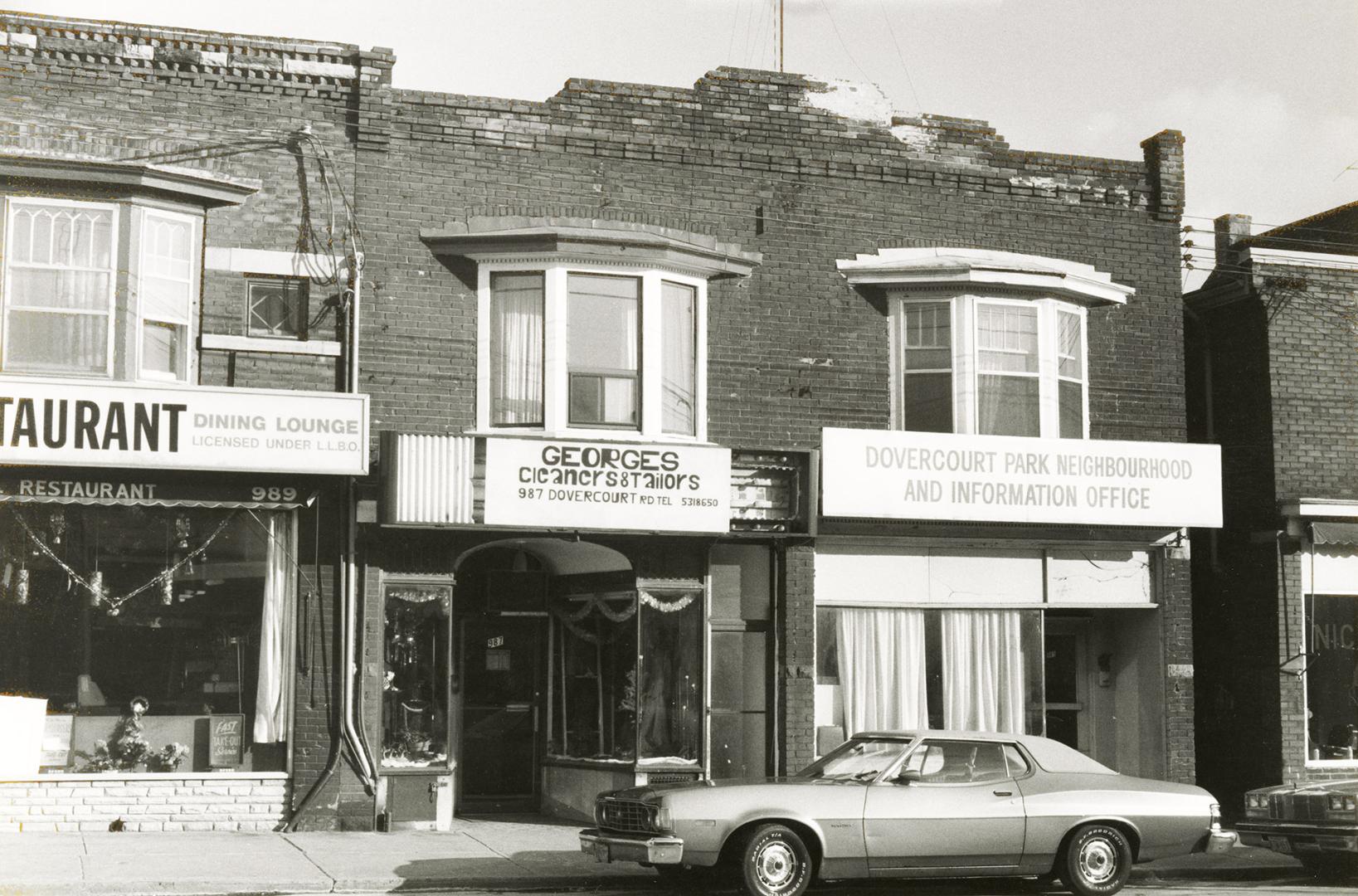 Shows three businesses of the type that has an apartment above the shop. The one on the left is ...