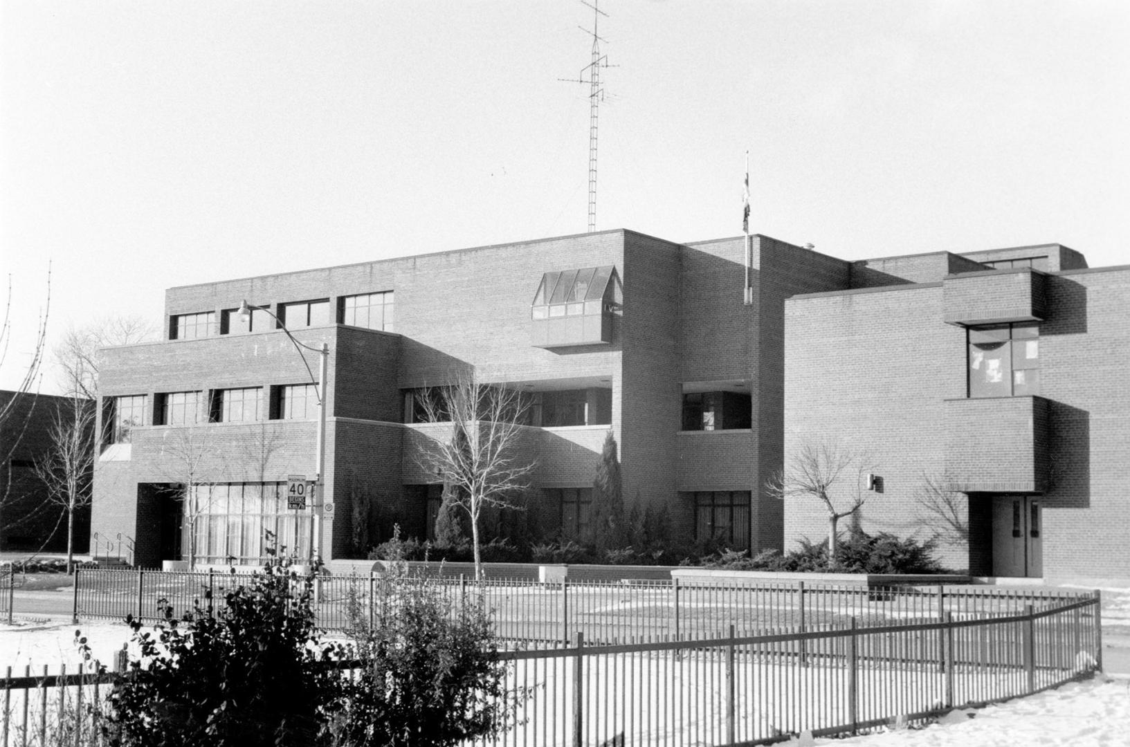 Shows a blocky brick building with 3 storeys, taken in winter.