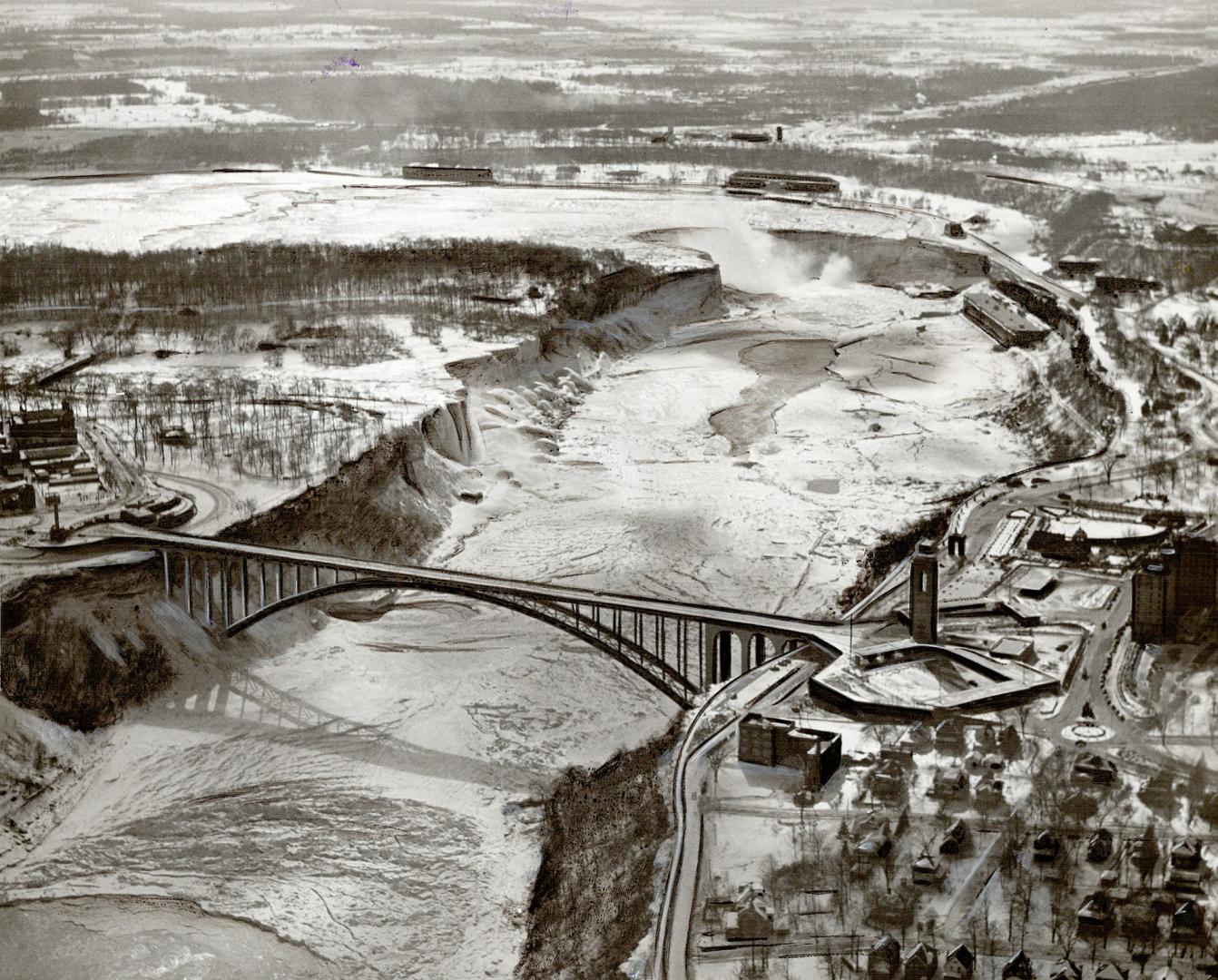 Winter's lovely, but has its drawbacks as revealed in this air view of Niagara Falls where the long ice bridge below the cataracts stretches from Hors(...)