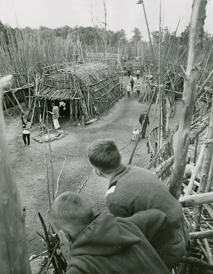 Visitors observing historic Sainte-Marie Among the Hurons in Midland, Ont.