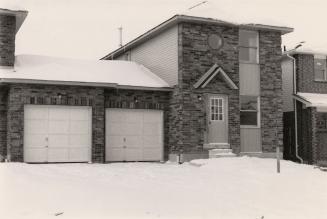 Semi-detached homes joined by garages. Ajax, Ontario