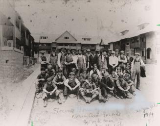 Workmen in front of Toronto housing project on Bain Avenue, Art Durnan (bottom right). Toronto, Ont.