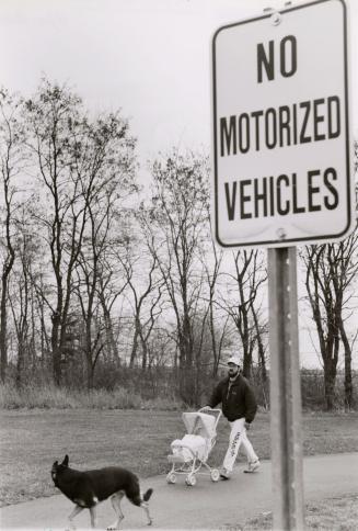 Doug Hawkins with son Jason in stroller on bike path. Ajax, Ontario