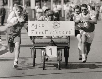 Ajax firefighter and winners in the Ajax-Pickering General Hospital bed race. Ajax, Ontario