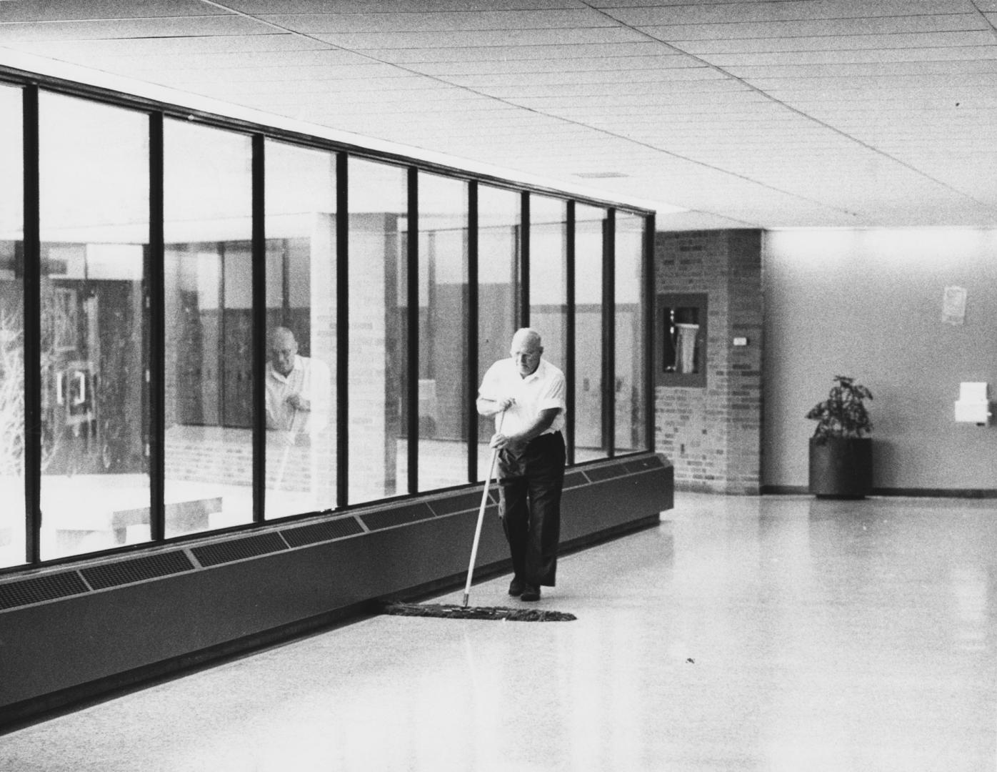 H.R. Dancy sweeping hall of school, Aurora, Ontario