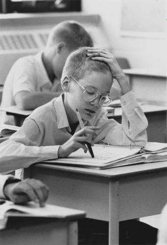 Martin Best works out a math problem in Grade 7 class at St Andrew's College, Aurora, Ontario