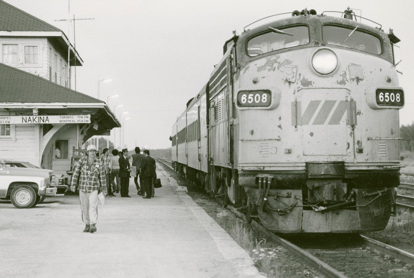 VIA Rail train and travellers at the train station. Nakina, Ont.