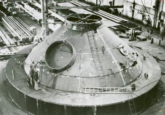 Workers inspecting blast furnace cone at the Dominion Bridge Co. Ltd. steel fabrication plant