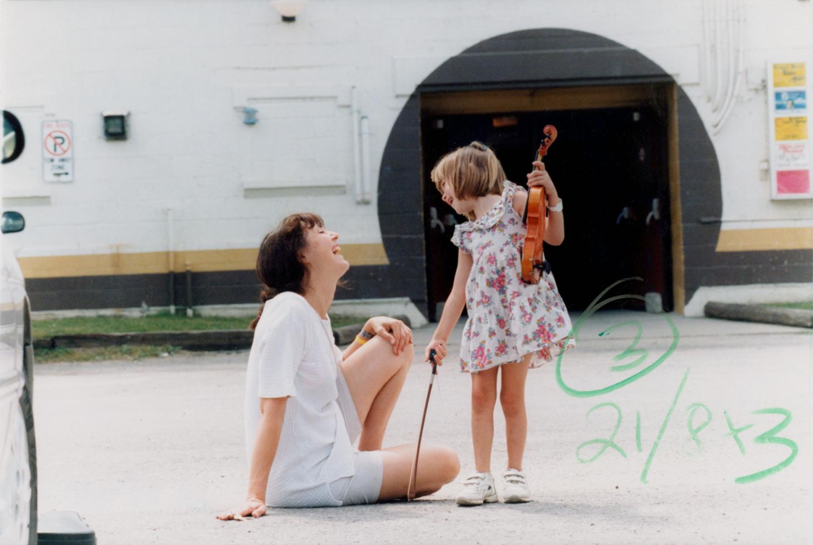 Savannah Dares, 4, and mother Karen in front of the Bobcaygeon Verulam Community Centre, Kawartha Lakes Ontario Open Fiddle and Step Dance Contest. Bobcaygeon, Ontario